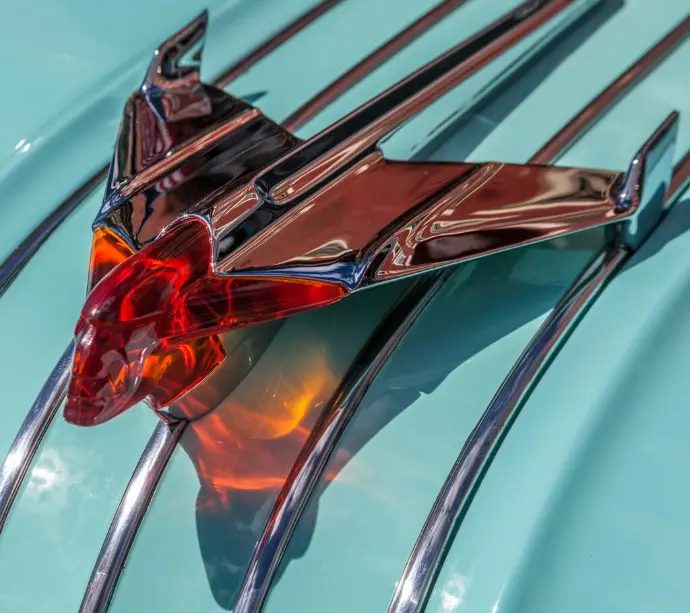 Photo of c. 1950 Pontiac Chieftain hood ornament winged rocket with lighted stylized Native American head